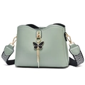 Minimalist light green shell crossbody bag with bow pendant and woven shoulder strap - Green