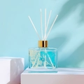 100ml square reed diffuser bottle with light blue liquid, dried flowers and white sticks - Blue Bell [100ml]
