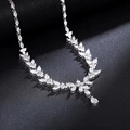 Exquisite silver necklace featuring flower and teardrop gemstones on a textured black surface - Necklace / Platinum Necklace