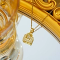 Elegant gold titanium necklace with a sparkling cubic zirconia lock pendant on a gold chain - Gold