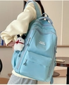 Detail of light blue backpack featuring multiple pockets and a cute white puppy plush charm - Pochacco Charm / Blue