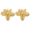 Close-up of golden flower earrings with hammered texture and white pearls in center - Gold