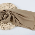Beige bubble chiffon hijab scarf with decorative pearls on a woven straw mat display - 90