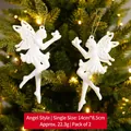 Set of 2 white glitter angel ornaments hanging on a Christmas tree with warm lights - Angel Style