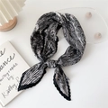 Pleated square scarf featuring black and white paisley pattern tied in a stylish knot - Paisley Floral Border Black