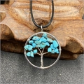 Macro detail of silver tree of life pendant featuring natural turquoise stone chips - Blue Turquoise (Synthetic)