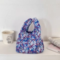Macro detail of corduroy lunch bag featuring dense blue and purple floral patterns - Dark Purple Floral