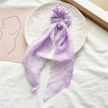 Detail of purple chiffon scrunchie with gold star pattern and long ribbon on a plate - Purple With Gold Stars