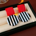 Detail view of retro geometric resin earrings with red square and black-white stripe pattern - Red Black White Striped Geometric Style