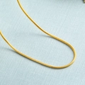 Elegant gold snake bone necklace featuring a smooth metallic finish on blue background - 1mm Snake Chain