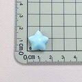 Detailed view of light blue resin star accessory measuring 1.8cm on a measuring mat - Light Blue