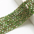 Close-up of 4x6mm green glass beads with gold trim for DIY jewelry making and craft - 4x6mm Gold Edged Seed Beads approx. 48pcs/Strand / Grass Green Gold Edge