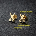 Detail shot of mini gold scissor earrings with size 0.9cm and weight 2g on black background - Scissors Shape (079 Gold)