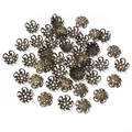 Macro shot of bronze hollow flower bead caps for DIY jewelry making and crafting - Antique Bronze