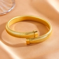 Detail of golden Tubogas spiral bracelet on silk fabric with high metallic luster - Gold Plain Bangle (R208)