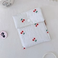 Detail of white quilted cherry print cosmetic bag with snap button closure and soft texture - Sanitary Bag (Horizontal Quilted)