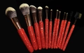 Detail of 12-piece makeup brush set featuring sparkling red rhinestone-encrusted handles - Red