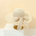 Elegant beige wide-brim straw sun hat with bow and white lace trim on a minimalist stand - M(56-58cm) / Beige