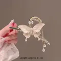 Elegant gold butterfly hair claw clip with pink pearls and tassel fringe, 11cm length - Cross Enamel Butterfly