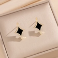 Golden star stud earrings with black inlay and crystals in a beige satin jewelry box - Black Shell Stud Earrings (840)