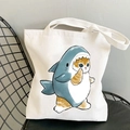 White canvas tote bag featuring a cute illustration of a cat wearing a shark costume - Cat in Shark Costume