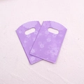 Macro detail of purple plastic jewelry bags featuring delicate cherry blossom prints - No.33-Purple Cherry Blossom