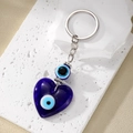 Bohemian heart-shaped evil eye keychain with blue glass pendant on stone base - Glass Heart Eye