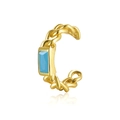 Golden woven ear cuff with turquoise gemstone on a white reflective background - Blue Turquoise - Gold