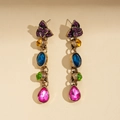 Detailed macro view of vintage gold earrings with colorful rhinestones and floral drop gems - Retro Colorful Gemstone Dangle Tassel Earrings / Colorful