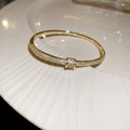 Close-up of 18k gold plated snake-style cuff bracelet with micro-paved zircons - 12# Golden Buckle