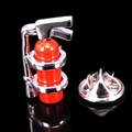 Macro view of a red fire extinguisher music brooch with silver metal butterfly clasp - Fire Extinguisher