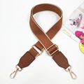 Close-up of brown canvas bag strap with golden metal hooks and adjustable buckle detailing - Brown & Brown