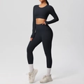 Detail of black seamless yoga set showing high-waist leggings and cropped long sleeve top - S / Black