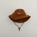 Detailed close-up of caramel bucket hat with lucky face embroidery and windproof cord - Lucky Smiley / Coffee