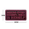 Embroidered morale patch featuring pink text on black rectangle for successful women - Behind Every Successful Woman Is Herself
