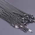 Detail of 2.5mm black stainless steel keel chains featuring lobster clasps and steel tags - Black