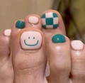 French press-on toenails featuring green and beige checkerboard with smiley face designs - FW25
