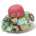 Close-up of summer sun hat with pink straw crown and colorful geometric print brim - M (56-58cm) / Watermelon red