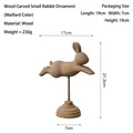 Modern minimalist wooden rabbit ornament in brown finish with circular base - Flying Little Rabbit Stand / Maillard Style