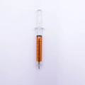 Syringe shaped ballpoint pen with orange liquid and black volume scale markings - Orange Barrel