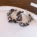 Close-up of leopard print fabric-wrapped hoop earrings with golden studs on a tray - Light Coffee Leopard Print Ruched Style (2# Silver Earring Post - Light Coffee Color)