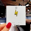 Vibrant yellow lightning bolt enamel pin displayed on a minimalist white card - 44*Yellow Lightning Bolt Pin
