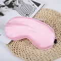 Pink silk sleep mask with elastic strap on woven mat, soft texture for travel - Deep Pink