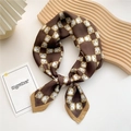 Brown silk-like square scarf with gold chain print on an elegant wooden display - Horseshoe Geometry Brown
