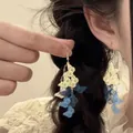 Detailed close-up of layered yellow and blue butterfly tassel drop earrings on model - 2# Butterfly Style - Ear Hook / White and Blue Contrast