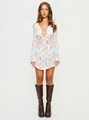 Detail of white lace crochet dress featuring long flared sleeves and lace-up front design - S / White
