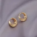 Elegant gold layered hoop earrings with textured curved lines on silk background - Three-Layer Curved Lines / E-095---Gold