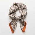 Elegant white silk scarf with brown rose pattern and orange borders tied in a bow - Red Border Coffee