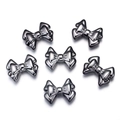 Macro detail of six metallic bow-shaped charms in a glossy gunmetal finish on white back - Gun Black