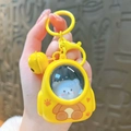 Cartoon glowing yellow backpack keychain featuring a blue bear doll inside a clear window - Glowing Cat Backpack - Yellow